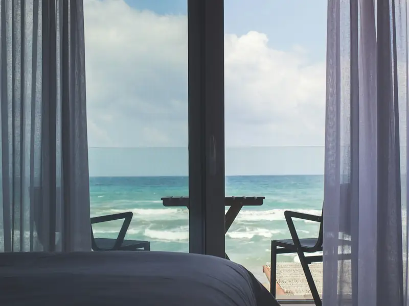 Illustrative hotel room looking out toward the sea